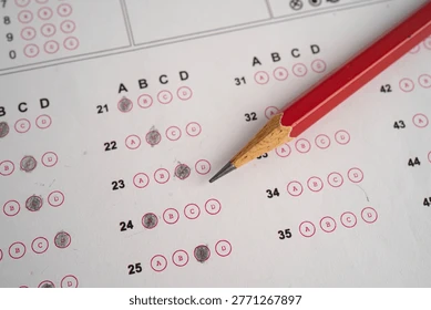A student carefully filling exam bubbles with 2B Pencils